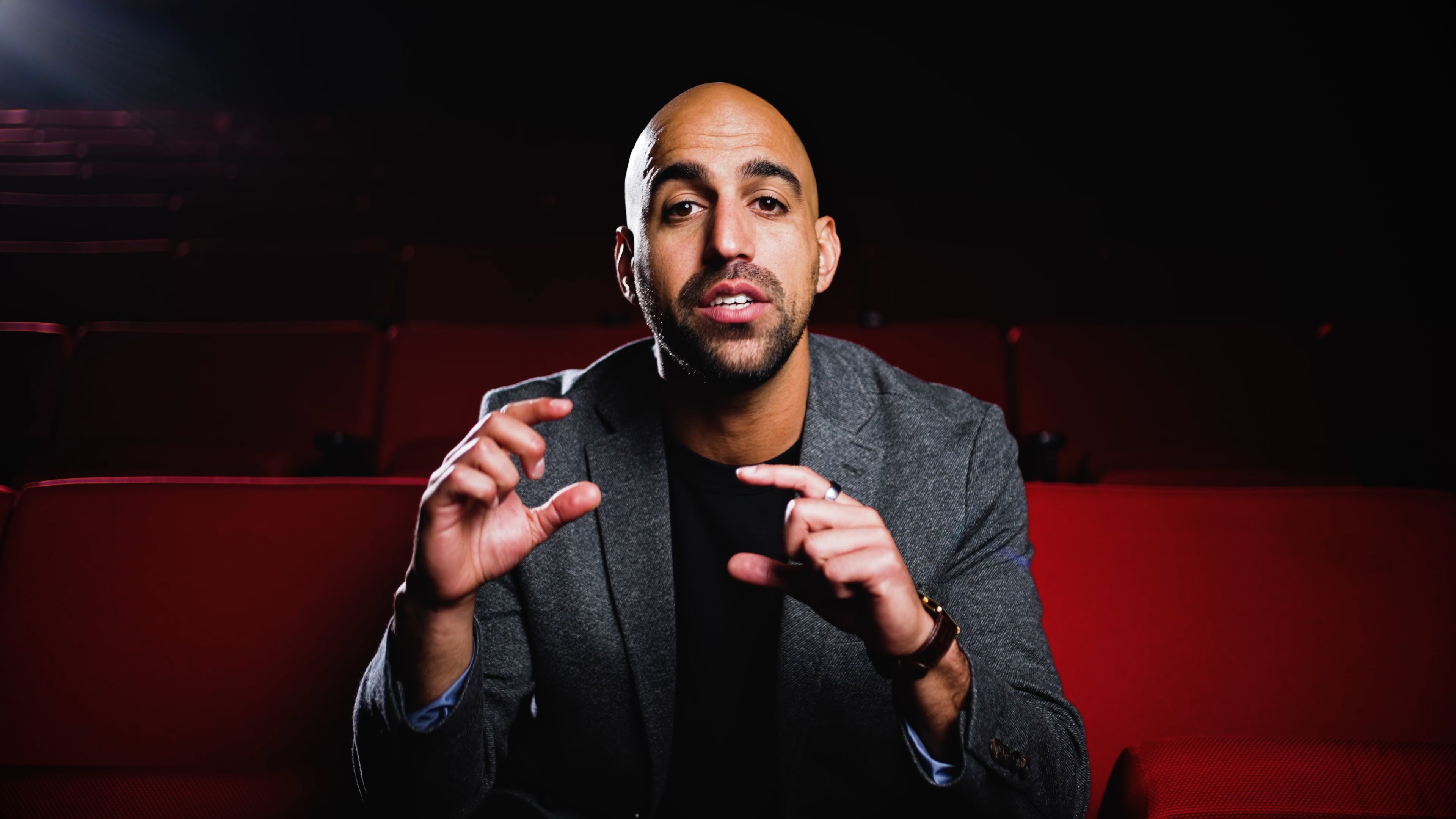 Kevin sharing ideas during an interview in a theater