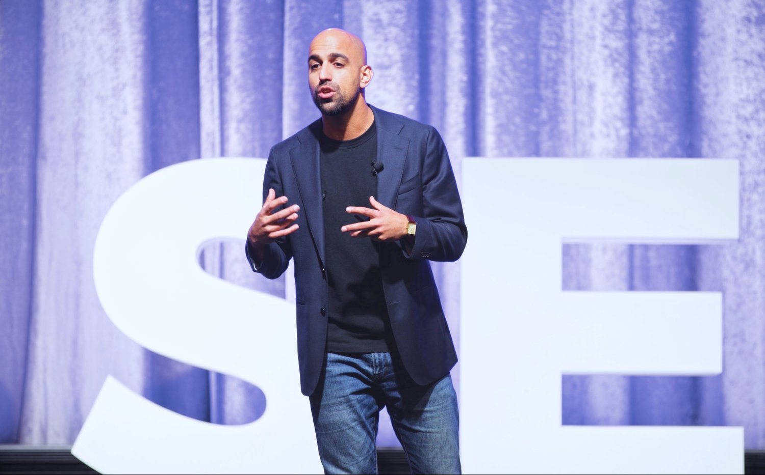 Kevin presenting on a conference stage